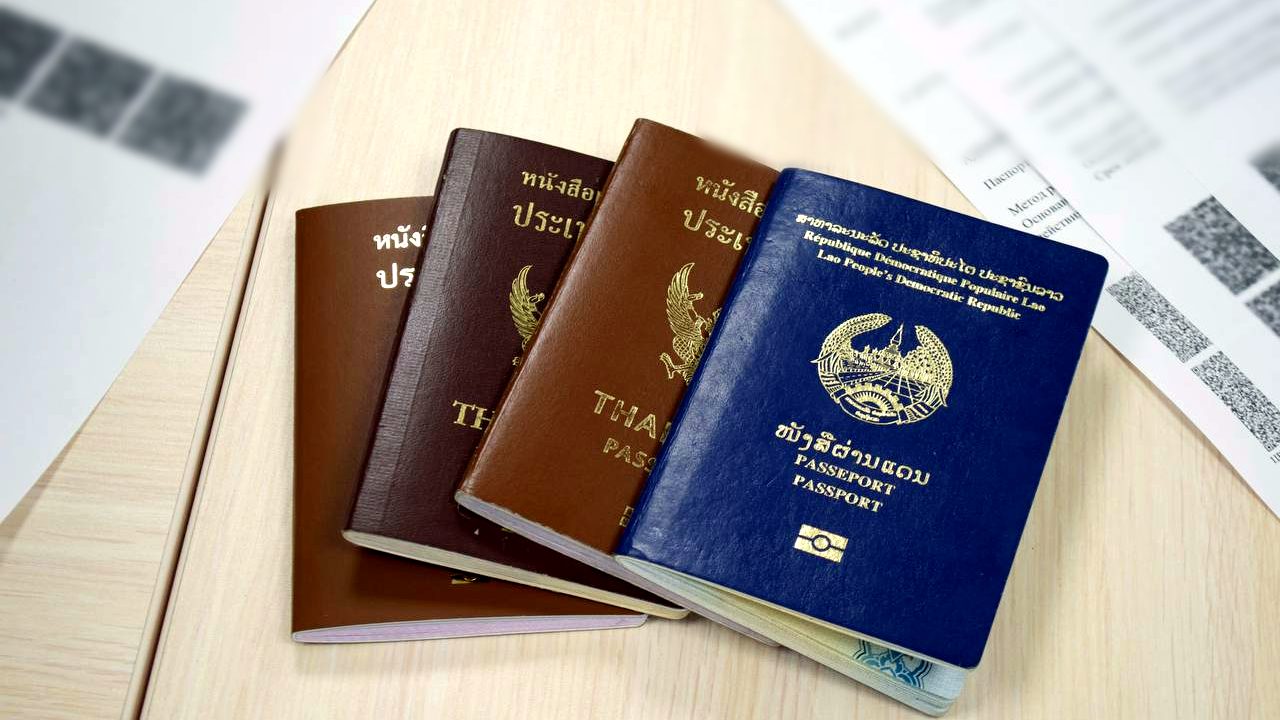 Passports of foreign workers from Thailand and Laos on a desk