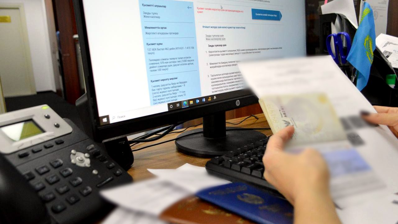 The e-government portal showing the work permit fee next to a foreign worker's documents